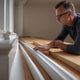 A homeowner compares modern and traditional skirting board profiles, examining their design and dimensions for the perfect fit in their home