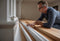 A homeowner compares modern and traditional skirting board profiles, examining their design and dimensions for the perfect fit in their home